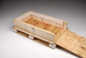 A wooden crate with a sliding lid on top.