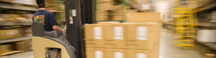 A forklift moving boxes in a warehouse.