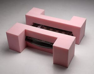 A pink object with a black strip on it.