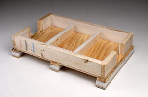 A wooden crate with three compartments on top of it.