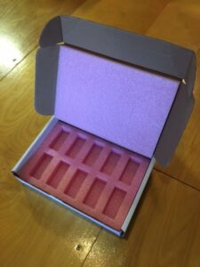 A box with some pink soap inside of it