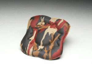 A red, brown and black camouflage seat cushion.