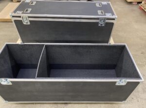 A pair of black boxes with metal corners.