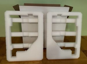 A pair of white bookends sitting on top of a table.